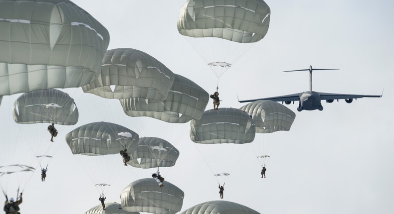 Army paratroopers from the 4th Infantry Brigade Combat Team (Airborne), 25th Infantry Division, U.S. Army Alaska, descend after jumping from a U.S. Air Force C-17 Globemaster III over Malemute Drop Zone during airborne training at Joint Base Elmendorf-Richardson, Alaska, March 24, 2022.U.S. Air Force photo by Alejandro Pea