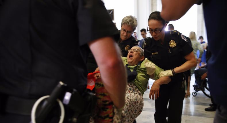 People are removed from a sit-in outside of Senate Majority Leader Mitch McConnell’s office as they protest proposed cuts to Medicaid, Thursday, June 22, 2017 on Capitol Hill in Washington.