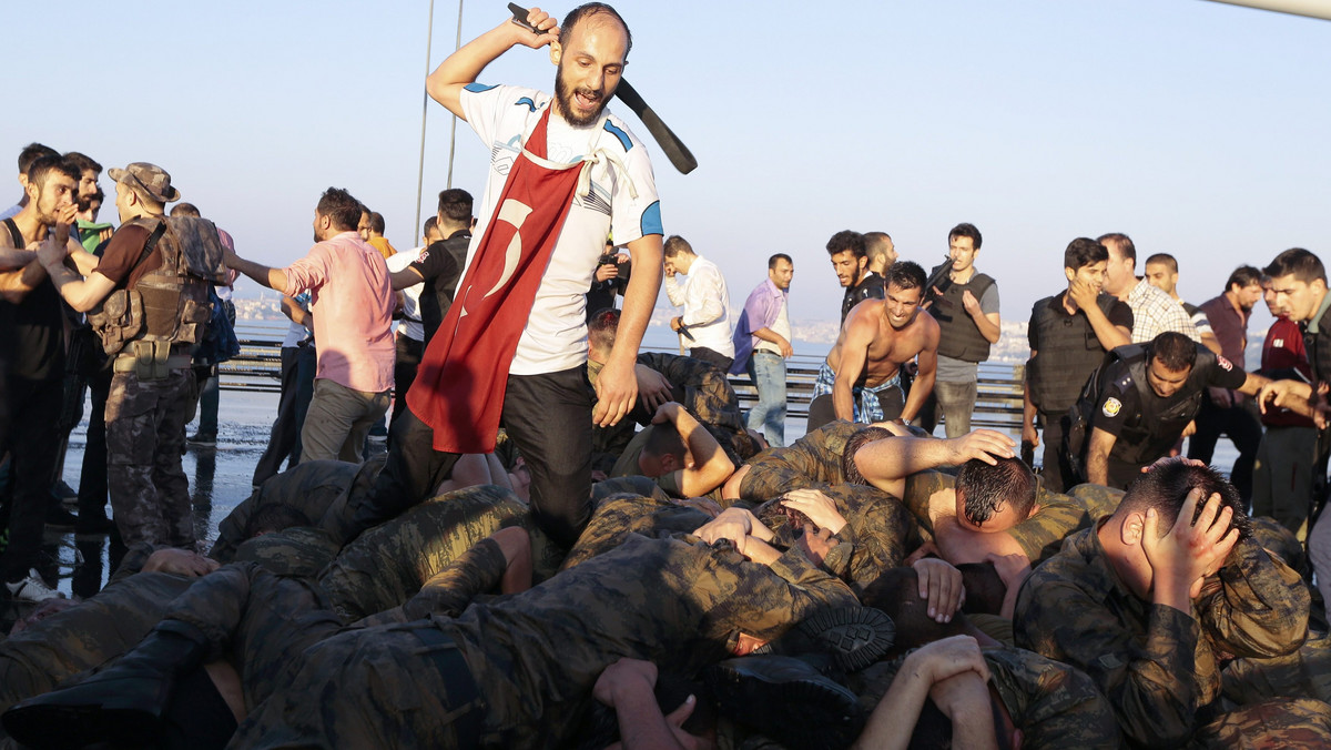 Surrendered Turkish soldiers who were involved in the coup are beaten by a civilian on Bosphorus bridge in Istanbul