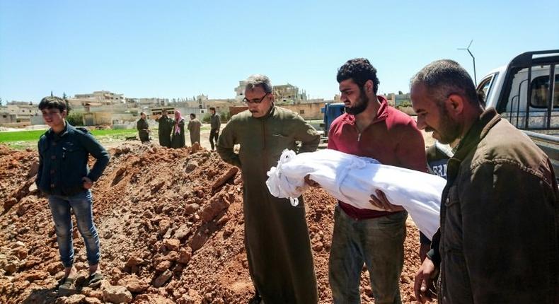 Syrians bury the bodies of victims of a a suspected chemical attack in Khan Sheikhun, a rebel-held town in Syria’s northwestern Idlib province, on April 5, 2017