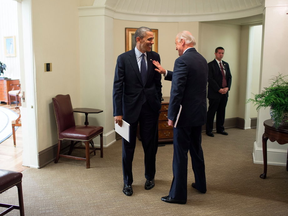 Obama and Biden speak in the hallway outside of the Oval Office following a meeting on Nov. 26, 2012.