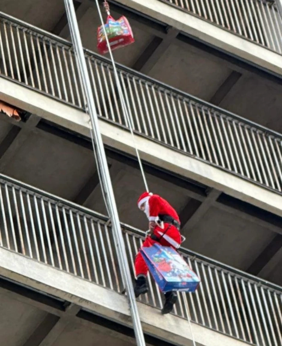 Pripadnici SAJ prerušeni u Deda mraza se spuštaju niz Institut za majku i dete 