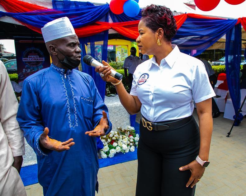 Mr Akeem Kolawole, N1 million winner and Funmi Sanni, National Sales Director, Dangote Cement Plc