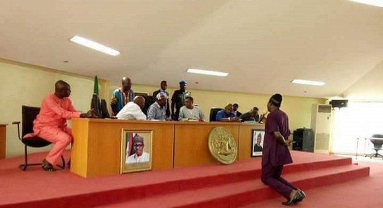 Hon. James Gbande kneeling before Governor Samuel Ortom