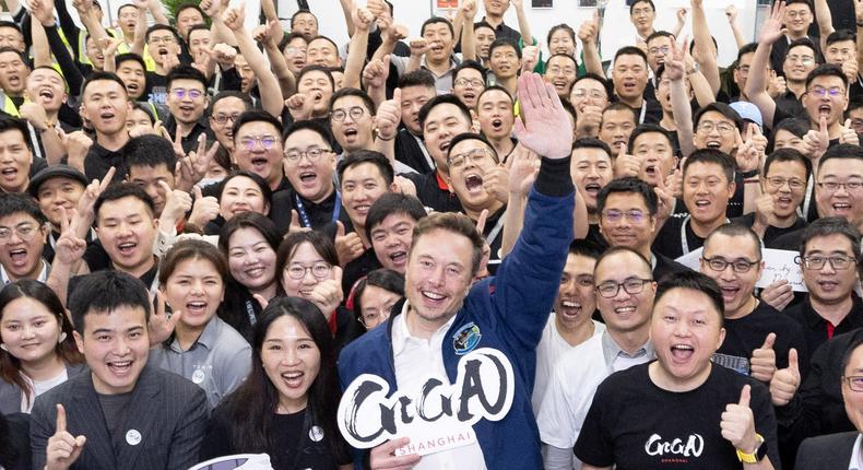 Elon Musk and staff from Tesla's Shanghai Gigafactory.Tesla/Handout via REUTERS