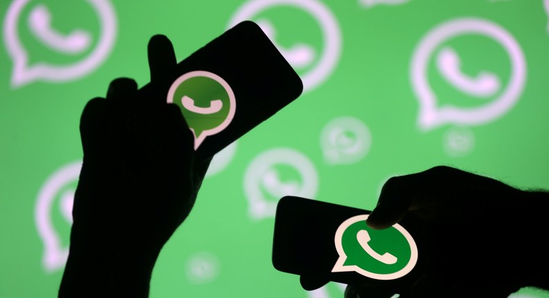 FILE PHOTO: Men pose with smartphones in front of displayed Whatsapp logo in this illustration September 14, 2017. REUTERS/Dado Ruvic