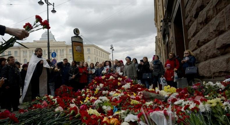 An Orthodox priest leads a service in memory of the victims of April 3 metro blast outside Technological Institute station in Saint Petersburg on April 5, 2017