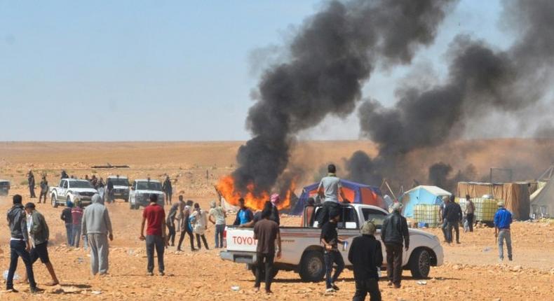 Smoke billows during clashes between Tunisian protesters and security forces outside the El Kamour oil and gas pumping station, in the southern state of Tataouine, on May 22, 2017