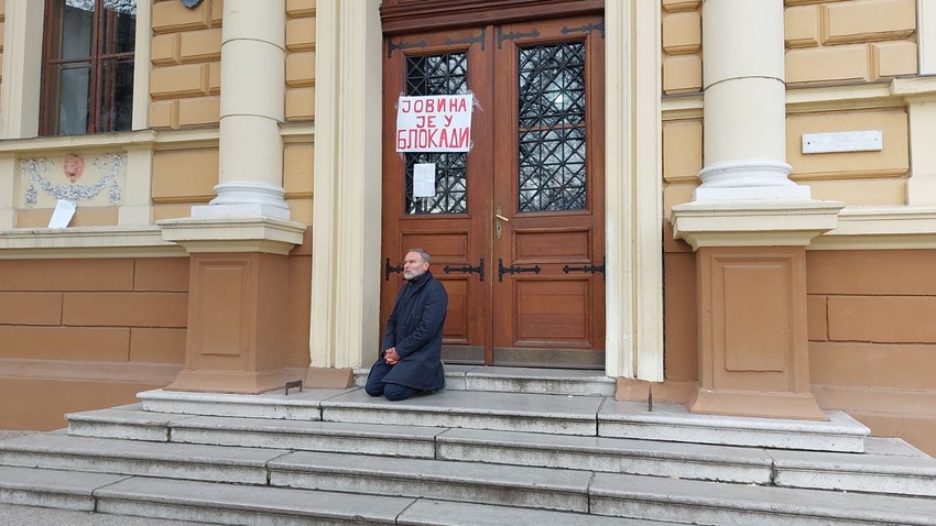 Direktor kleči ispred ulaza