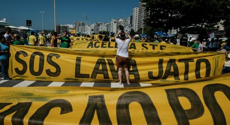 Demonstrators march along Copacabana Beach in Rio de Janeiro, Brazil, on March 26, 2017 during a nationwide protest against political corruption