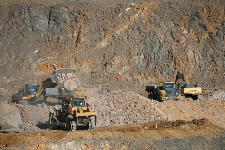 FILE PHOTO: Wheel loaders fill trucks with ore at the MP Materials rare earth mine in Mountain PassReuters