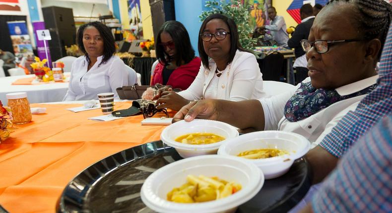 A volunteer serves Joumou soup to guests during the 11th annual Haitian Community Thanksgiving Brunch at the Caribbean Market Place in 2017.