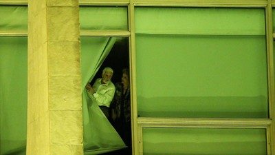 Brazil's President Rousseff and Chief of Staff Wagner look from a window at Planalto Palace in Brasi