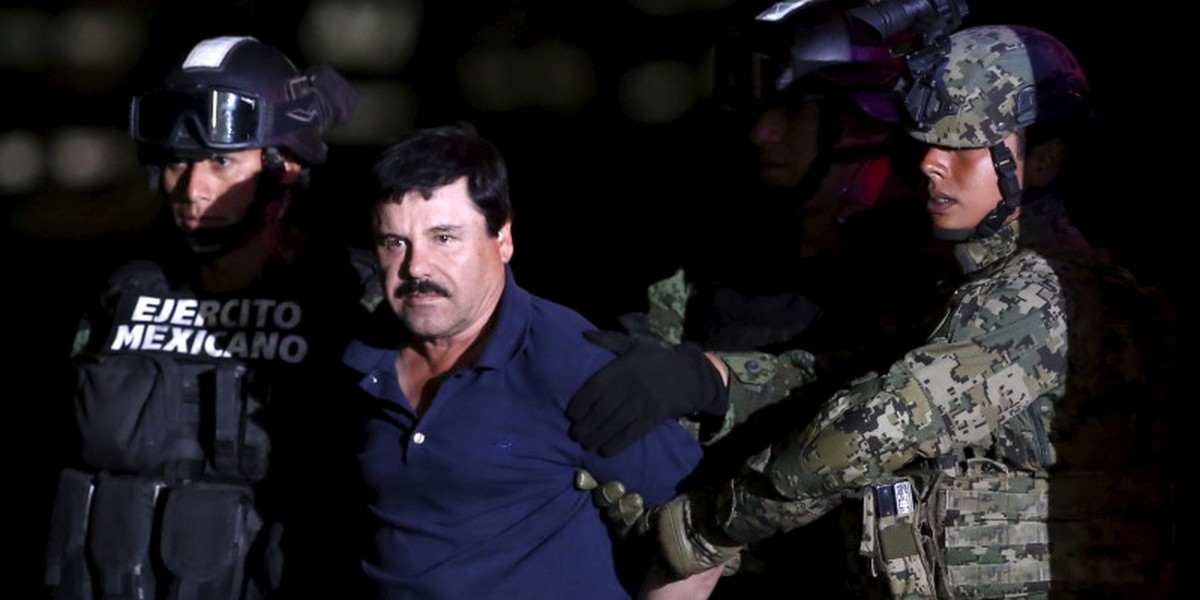 Joaquín "El Chapo" Guzmán is escorted by soldiers during a presentation at the hangar belonging to the office of the attorney general in Mexico City.
