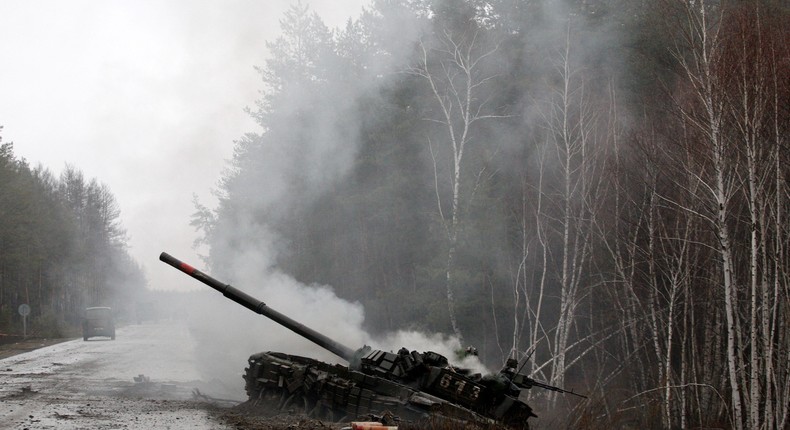 Smoke rises from a Russian tank damaged during the early days of Putin's invasion of Ukraine.