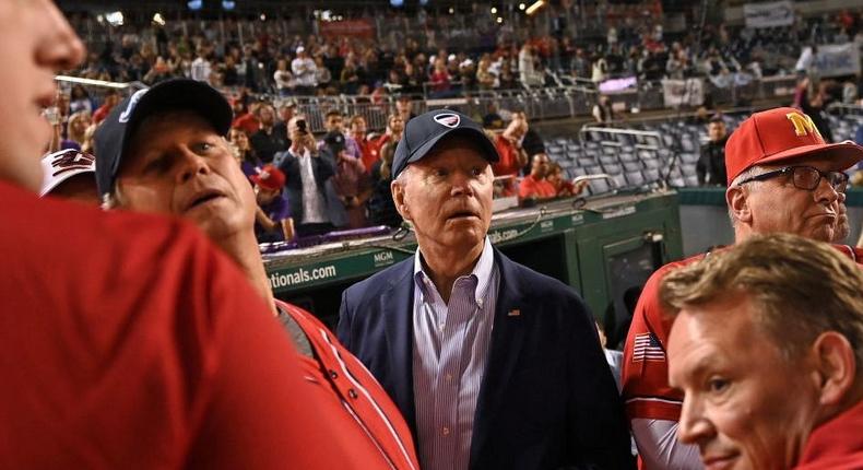 US President Joe Biden (C) watches the Congressional Baseball Game from the Republicans dugout at Nationals Park in Washington, DC on September 29, 2021. - Biden was inducted into the Congressional Baseball Hall of Fame earlier this evening.
