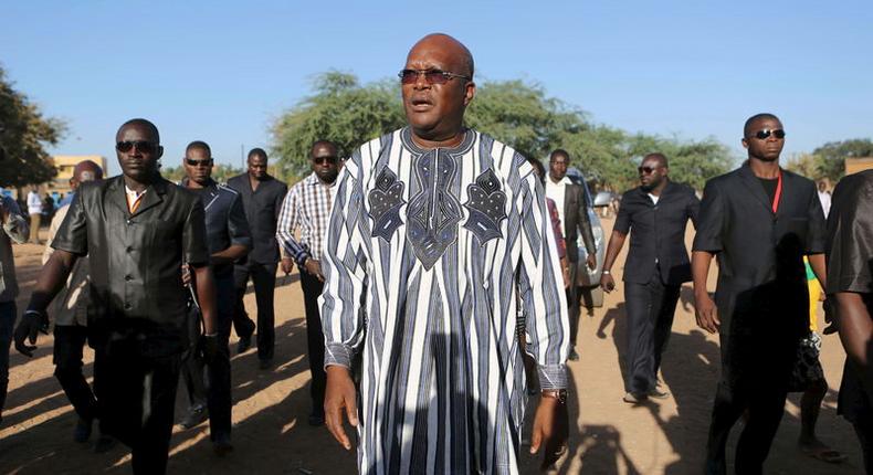 Presidential candidate Roch Marc Kabore (C) arrives to vote during the presidential and legislative election at a polling station in Ouagadougou, Burkina Faso, November 29, 2015. REUTERS/Joe Penney