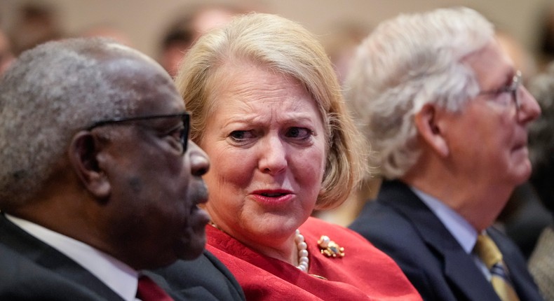 Associate Supreme Court Justice Clarence Thomas sits with his wife and conservative activist Virginia Thomas while he waits to speak at the Heritage Foundation on October 21, 2021.