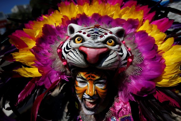 A member of the Congo Reformado folk group poses for a portrait before a parade at the 12th Intern