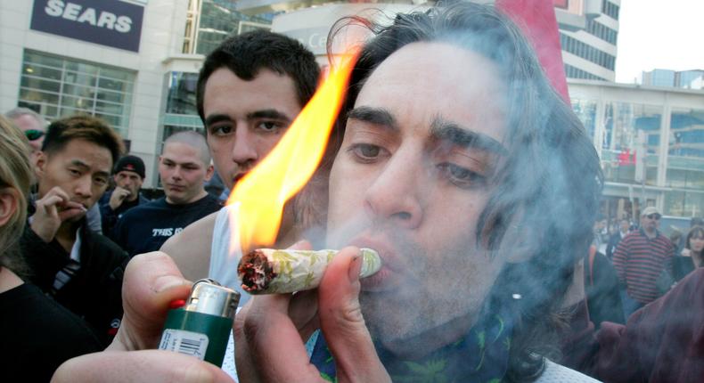 A man lights a marijuana joint at Dundas Square in Toronto April 20, 2007. Marijuana smokers gather on April 20 every year to publicly push for its legalization