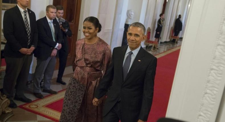 US President Barack Obama and First Lady Michelle Obama arrive to present the Presidential Medal of Freedom, the nation's highest civilian honor, during a ceremony in the East Room of the White House in Washington, DC, November 22, 2016