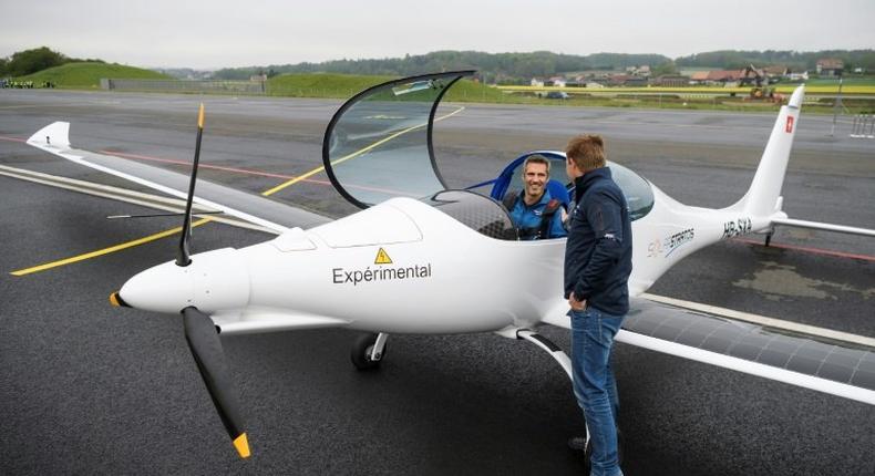 Raphael Domjan, who initiated the SolarStratos project, shakes hands with pilot Damian Hischier after the first test flight in Payerne, Switzerland