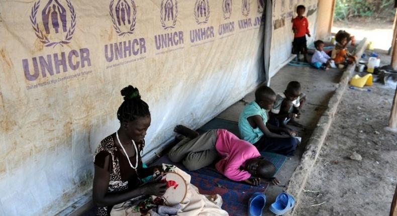 South Sudanese refugees wait outside their tent in Kakuma refugee camp, northwestern Kenya, on September 6, 2010