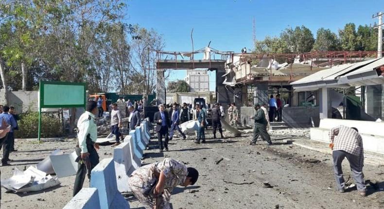 Iranian police survey the aftermath of a suicide car bombing which killed at least two people and wounded many more outside police headquarters in the southeastern port city of Chabahar