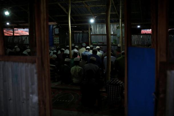 Rohingya refugees attend evening prayers at the Balukhali refugee camp near Cox's Bazar