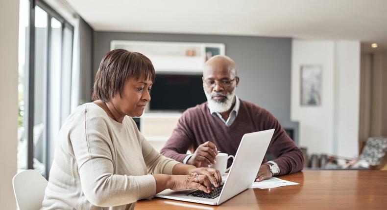 older couple doing paperwork at home