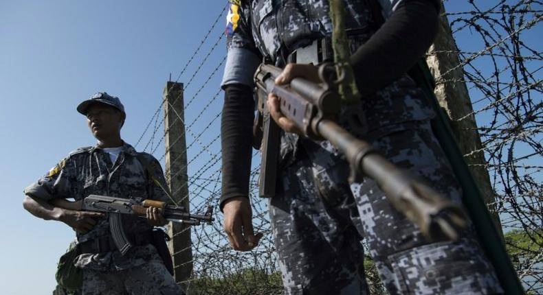 An armed Myanmar border police patrol along the river dividing Myanmar and Bangladesh border located in Maungdaw, Rakhine State on October 15, 2016