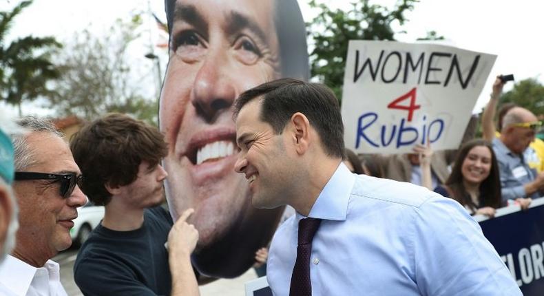 Marco Rubio (C) beat back a challenge from Democrat Patrick Murphy to hold onto his US Senate seat and win a second term