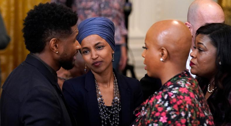 Usher speaks with Rep. Ilhan Omar, D-Minn., second from left, and Rep. Ayanna Pressley, D-Mass., second from right, as they arrive for an event to mark the passage of the Juneteenth National Independence Day Act, in the East Room of the White House, Thursday, June 17, 2021, in Washington.
