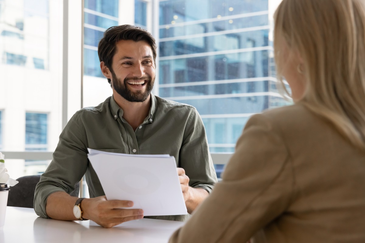Cheerful,Young,Employer,Man,Holding,Paper,Resume,,Talking,To,Job