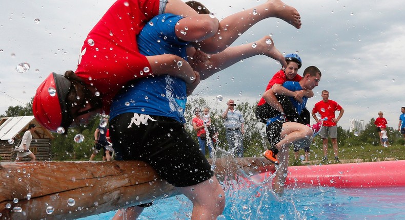 Men carrying their wives during the Wife Carrying competition to mark the City Day in Krasnoyarsk, Siberia, in Russia.