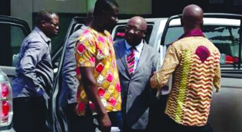 Pastor (in suit) arraigned before court for stealing power