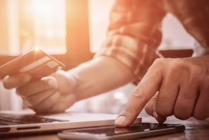 Online payment,Man's hands pointing smartphone and using credit card for online shopping.