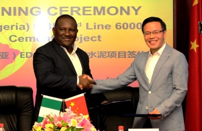 Abdulsamad Rabiu, Chairman, BUA Group and Tong Laigou, Board Chairman, SINOMA CBMI, shake hands and exchange documents after signing a USD600 million deal to expand BUA's cement capacity in Africa.