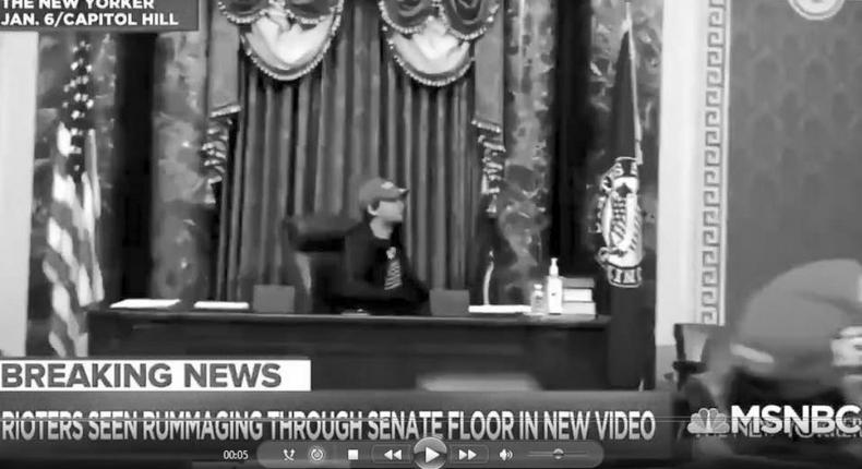 Christian Secor sits in Mike Pence's seat in the Senate on January 6, 2021.