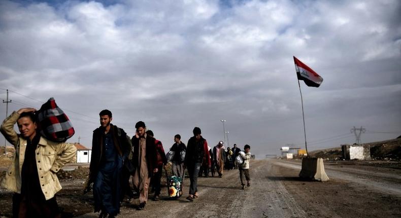 Displaced residents of western Mosul evacuate the area on March 14, 2017