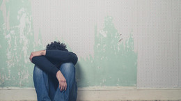 Sad young man in empty room