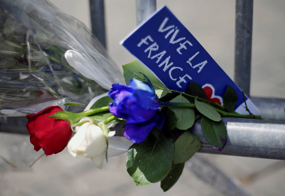 Flowers attached to a fence to remember the victims in front of the French embassy in Rome on Friday.