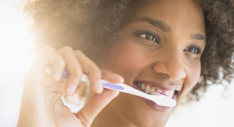 Lady brushing her teeth