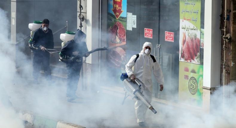 Iranian firefighters and municipality workers disinfect streets in the capital Tehran in a bid to halt the wild spread of coronavirus