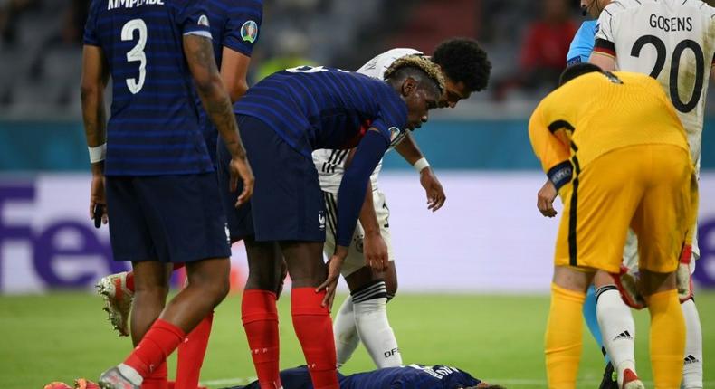 France's defender Benjamin Pavard (C) was hurt in a collision with German defender Robin Gosens Creator: Matthias Hangst