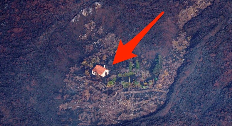 Lava flows surrounded a house following the eruption of a volcano in the Cumbre Vieja national park at El Paso, on the Canary Island of La Palma, Spain September 23, 2021.
