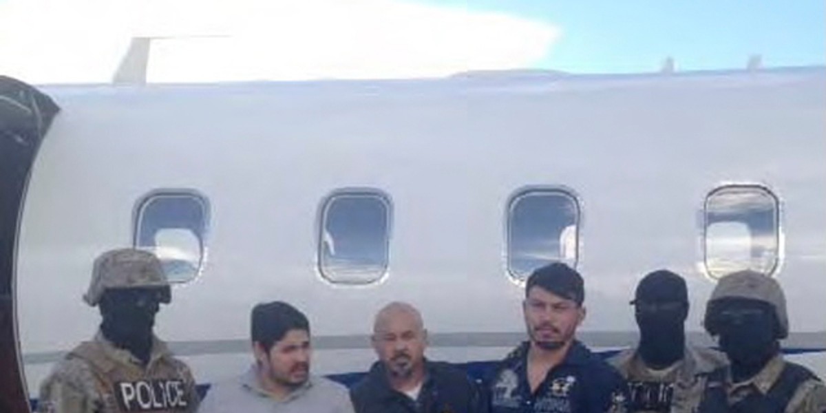 Efrain Antonio Campo Flores and Franqui Fancisco Flores de Freitas with Haitian law-enforcement officers in this November 12, 2015, photo, taken after their arrest in Port Au Prince, Haiti.