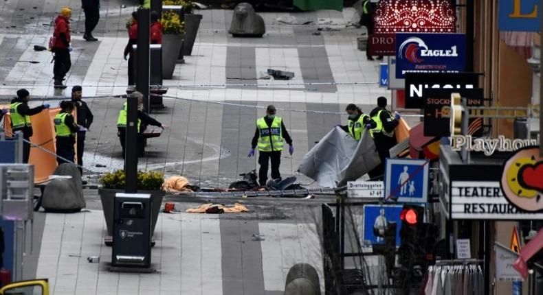 Emergency services work at the scene where a truck crashed into the Ahlens department store at Drottninggatan in central Stockholm, April 7, 2017