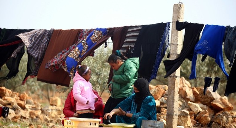 Displaced Syrians, who fled their hometowns due to clashes between regime forces and the Islamic State (IS) group, do their laundry in Kharufiyah, 18 kilometres south of Manbij, on March 4, 2017