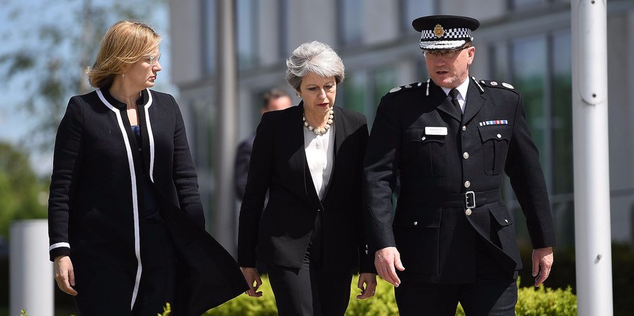 Home Secretary Amber Rudd and Britain's Prime Minister Theresa May (C) meet Chief Constable of Greater Manchester Police Ian Hopkins.